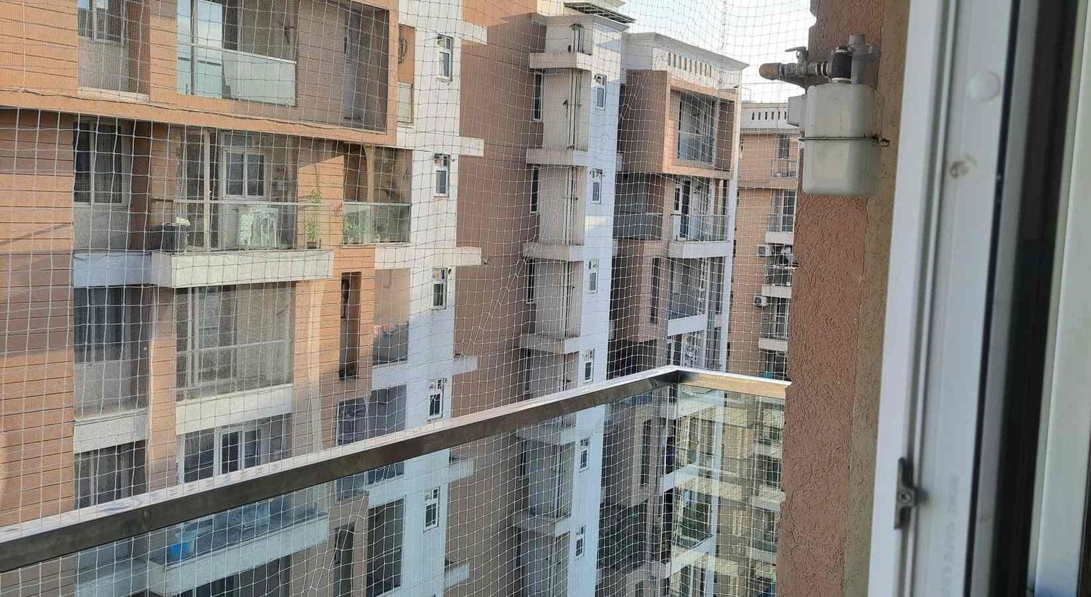 A balcony with a view of a city and buildings.