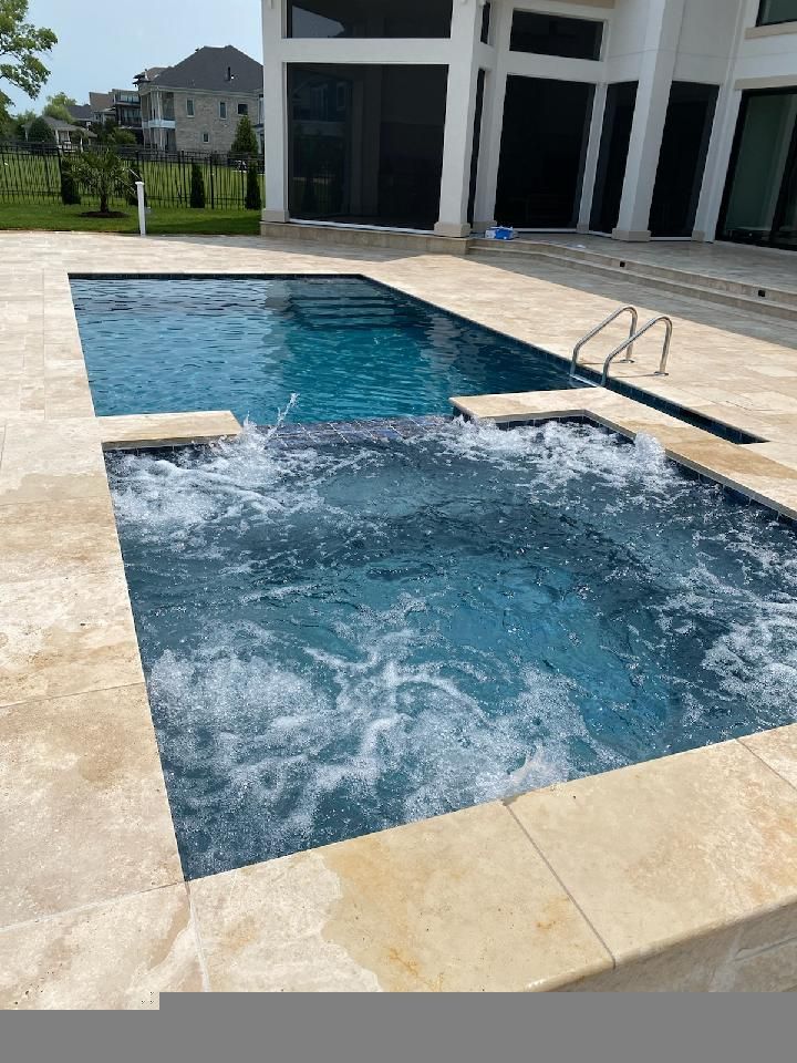 a large swimming pool with a hot tub in the middle of it .| Virginia Beach, VA | Atlantis Pools