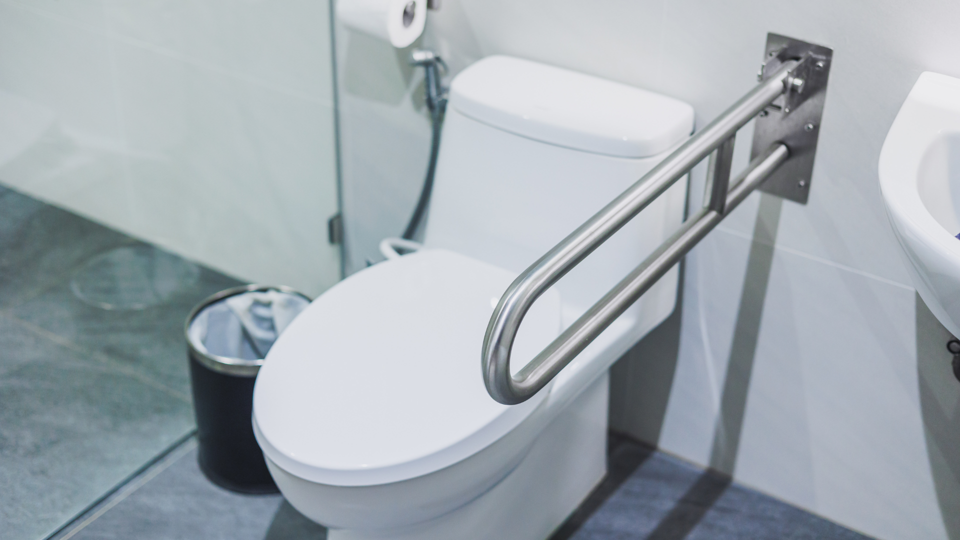 A clean, well-maintained office restroom with visible attention to grout, fixtures, and sanitation details.
