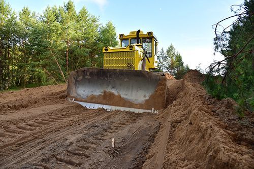 Dozer during clearing forest for construction new road