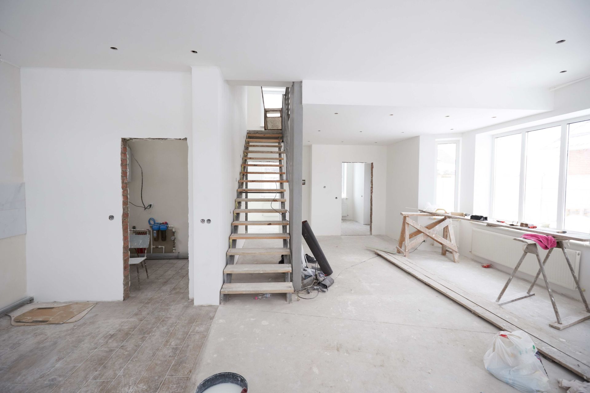 an empty room with a staircase going up to the second floor