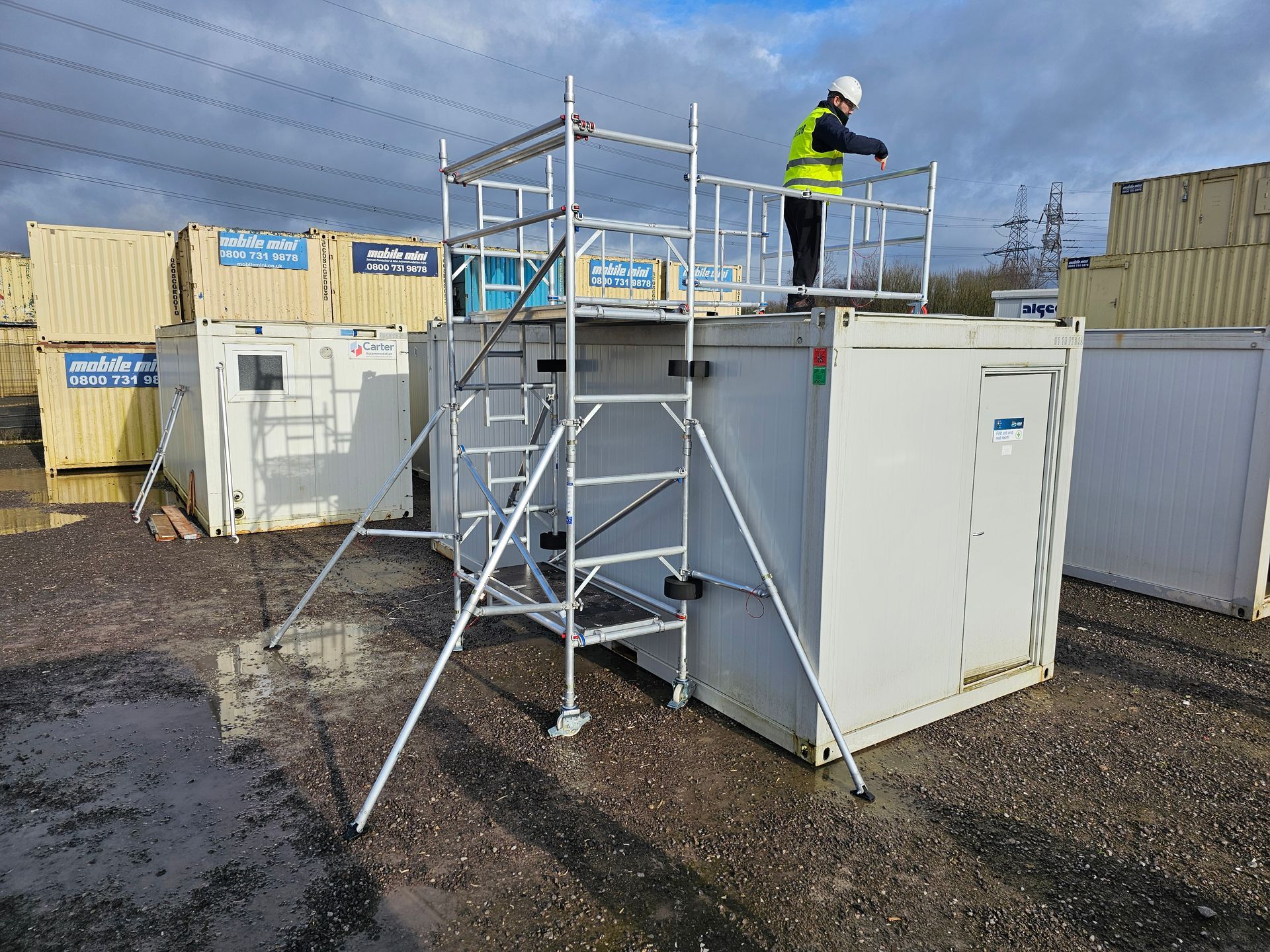 Maintenance worker using the Boxing Ring Tower to access the roof of a portable building