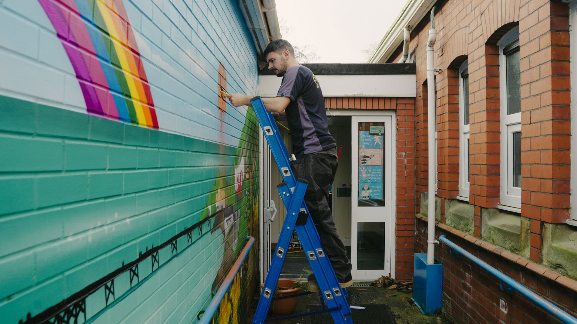 Electrician using the GFLCL Glassfibre Professional Combination Ladder to fix electrical wiring while working at height