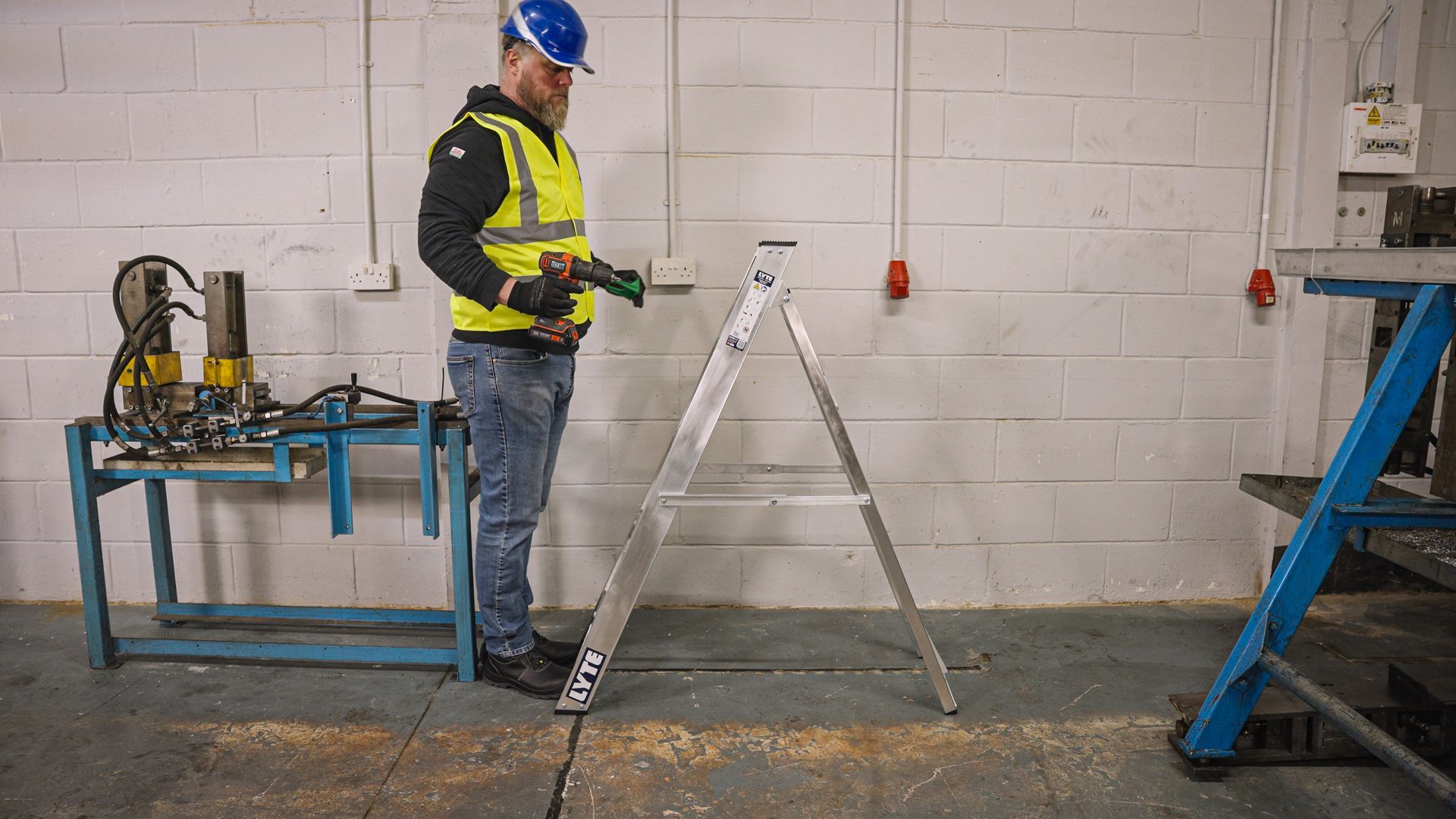 Worker standing in front of a step ladder