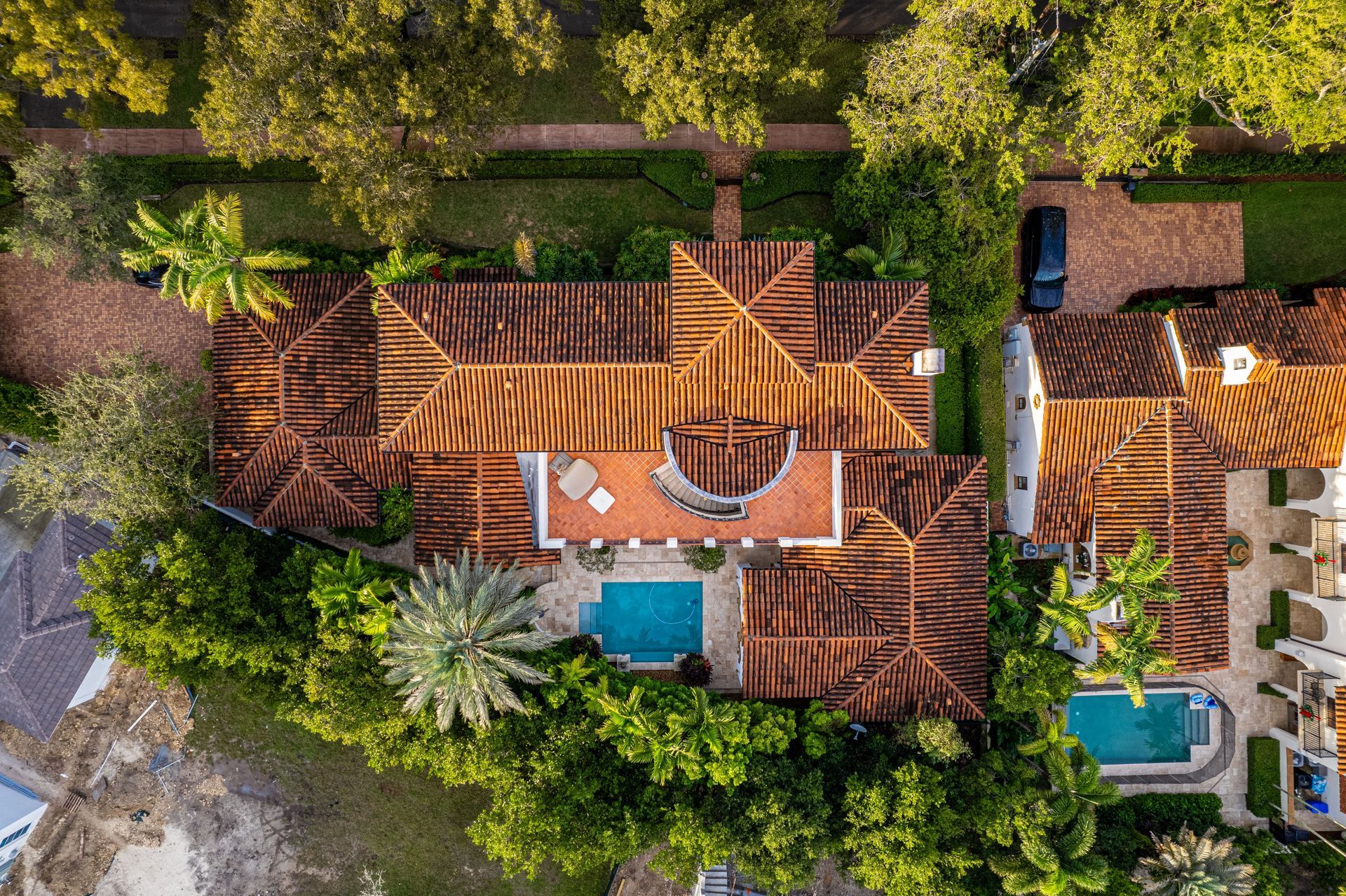 Aerial view of a South Florida home with a barrel tile roof and pool, typical of Pompano Beach