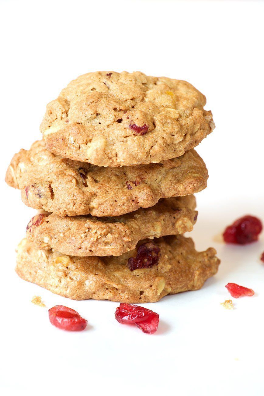 Four cookies are stacked on top of each other on a white surface.