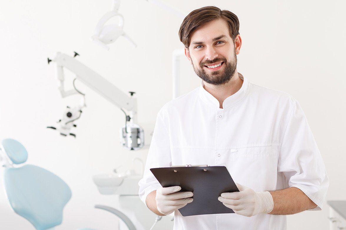 a dentist is smiling while holding a clipboard