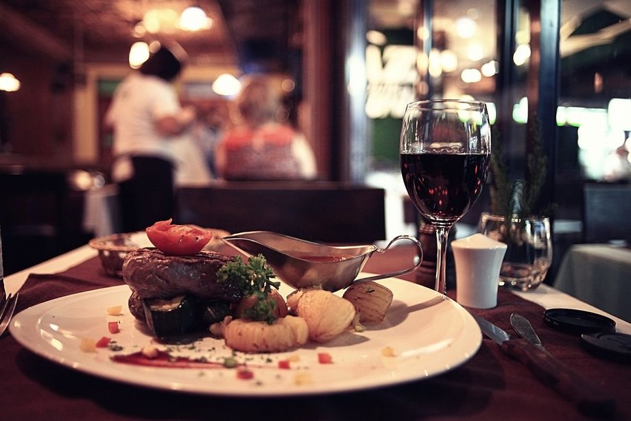 a plate of food and a glass of wine on a table