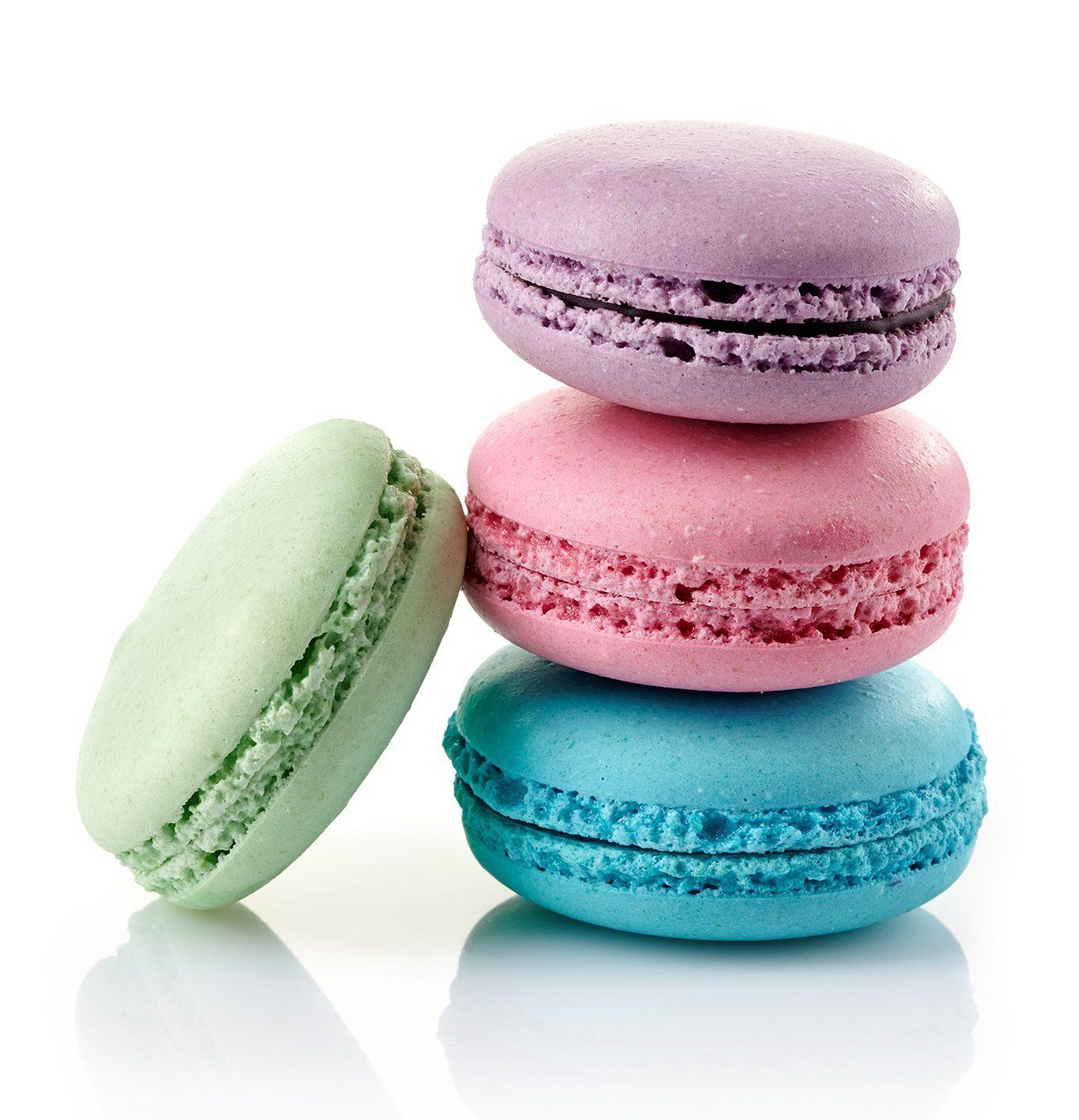 Three different colored macarons are stacked on top of each other