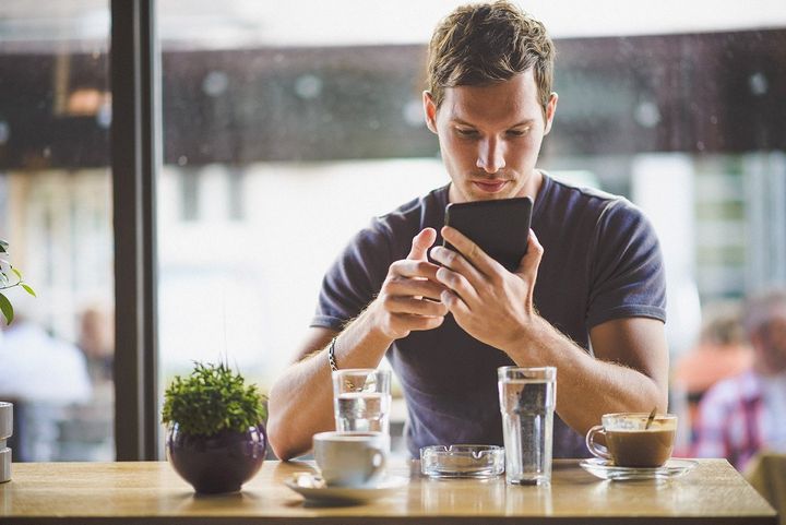 image of a person looking at their mobile