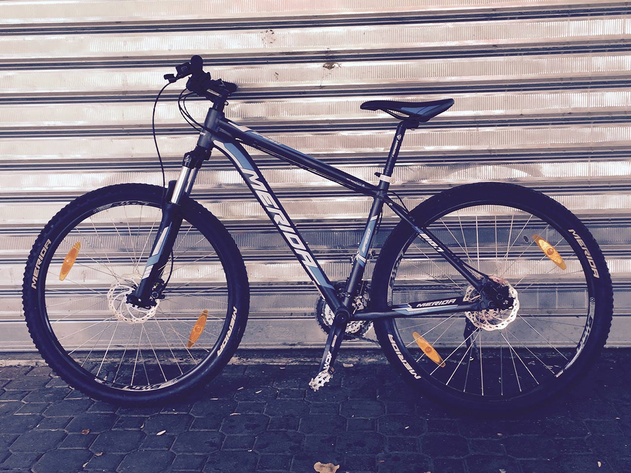 A bicycle is parked in front of a garage door