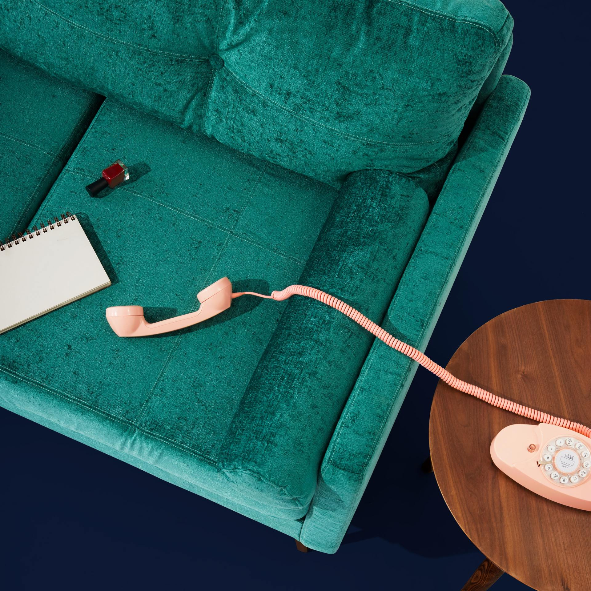 A CHAIR WITH A CORDED PHONE AND NOTEBOOK