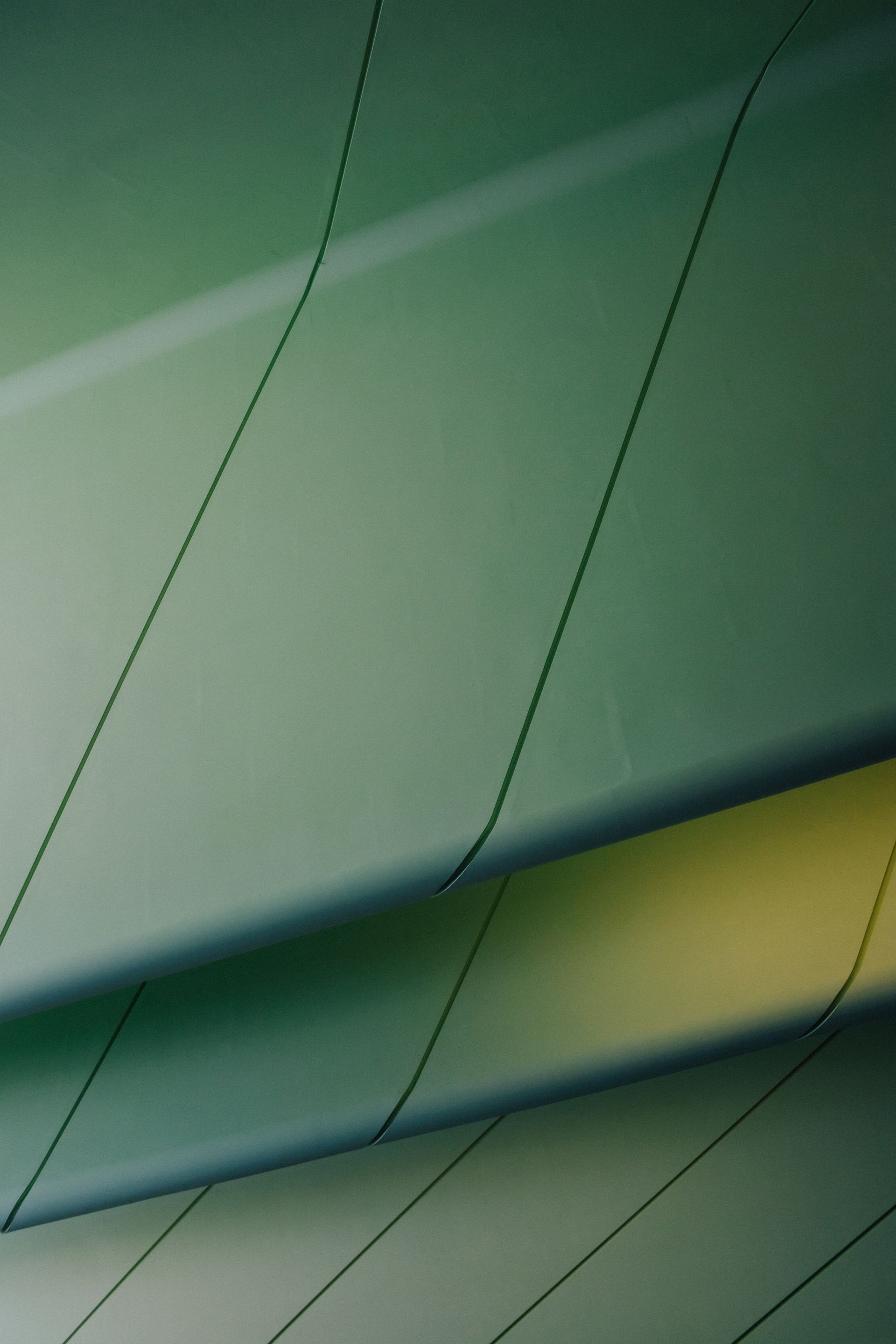 Green metal panels with thin black lines, abstract composition.