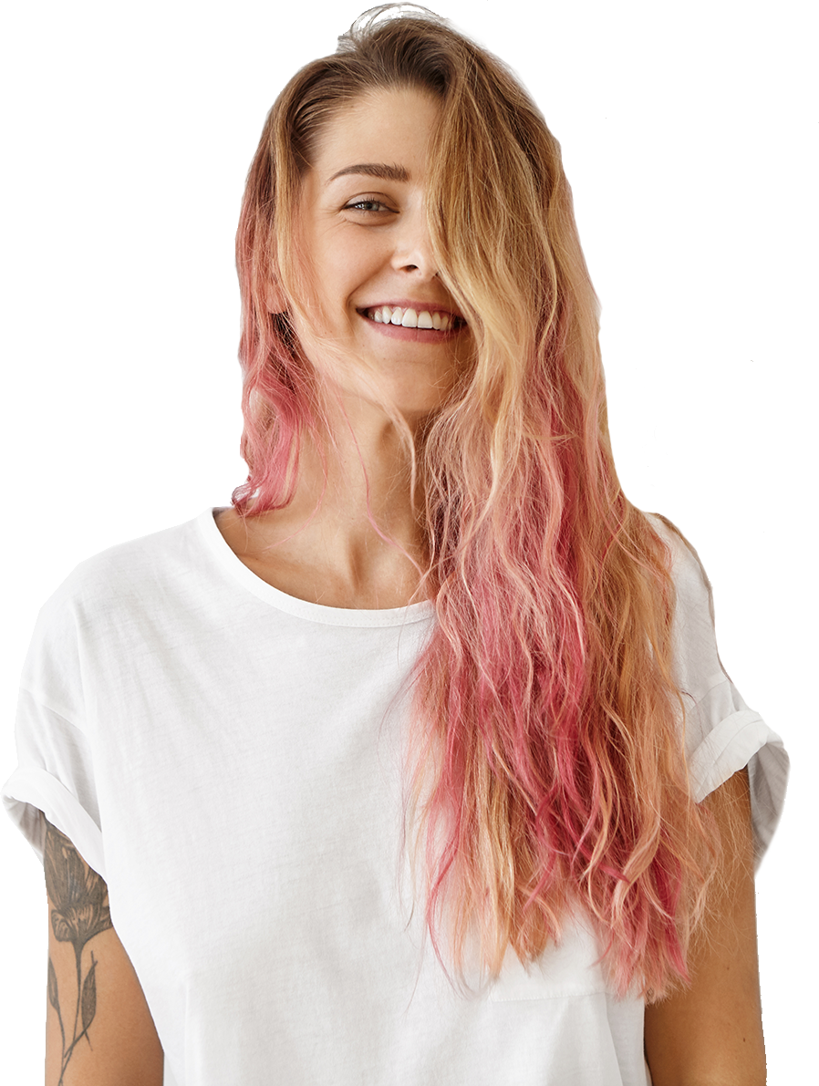 A woman with pink hair is wearing a white t-shirt and smiling.