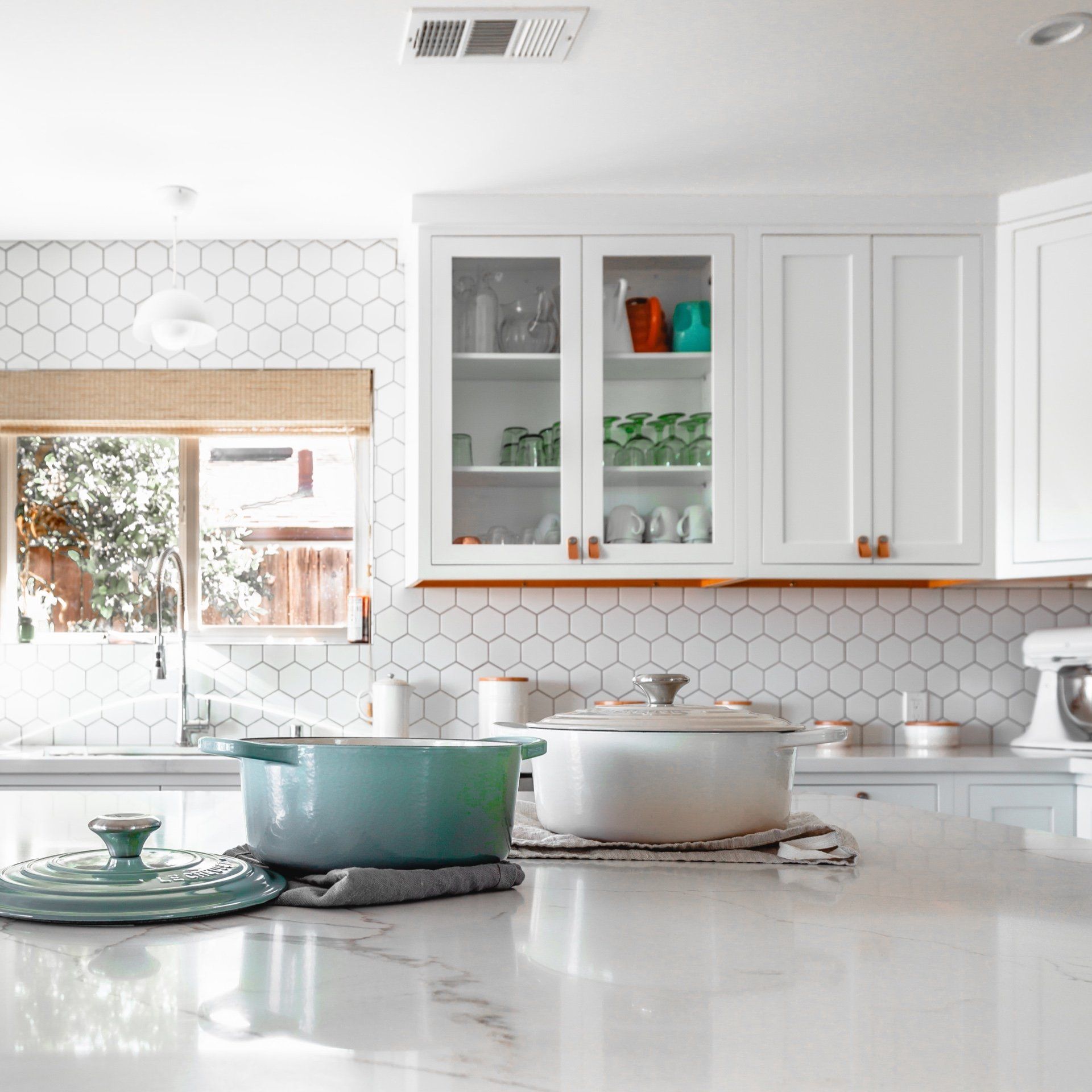 A kitchen with a lot of pots and pans on the counter.