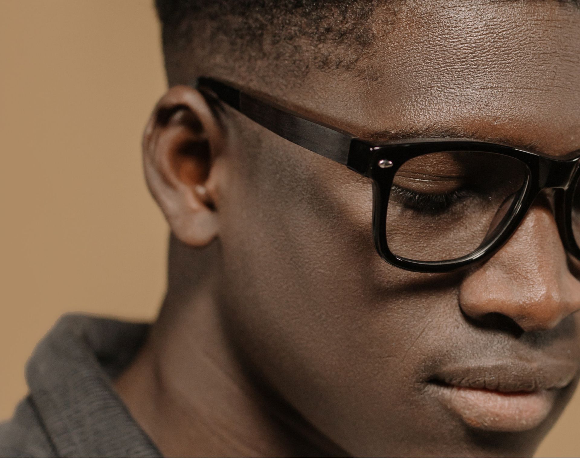 A close up of a man wearing glasses with his eyes closed
