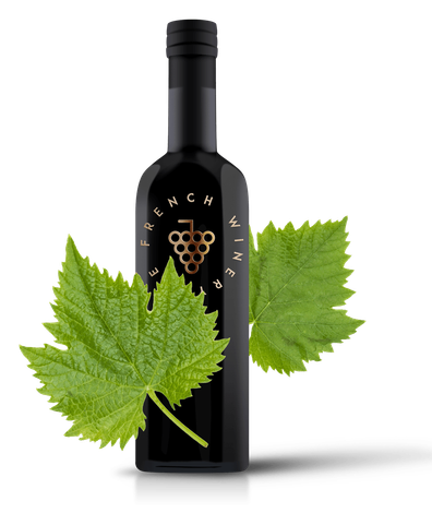 A bottle of wine next to a bunch of green leaves