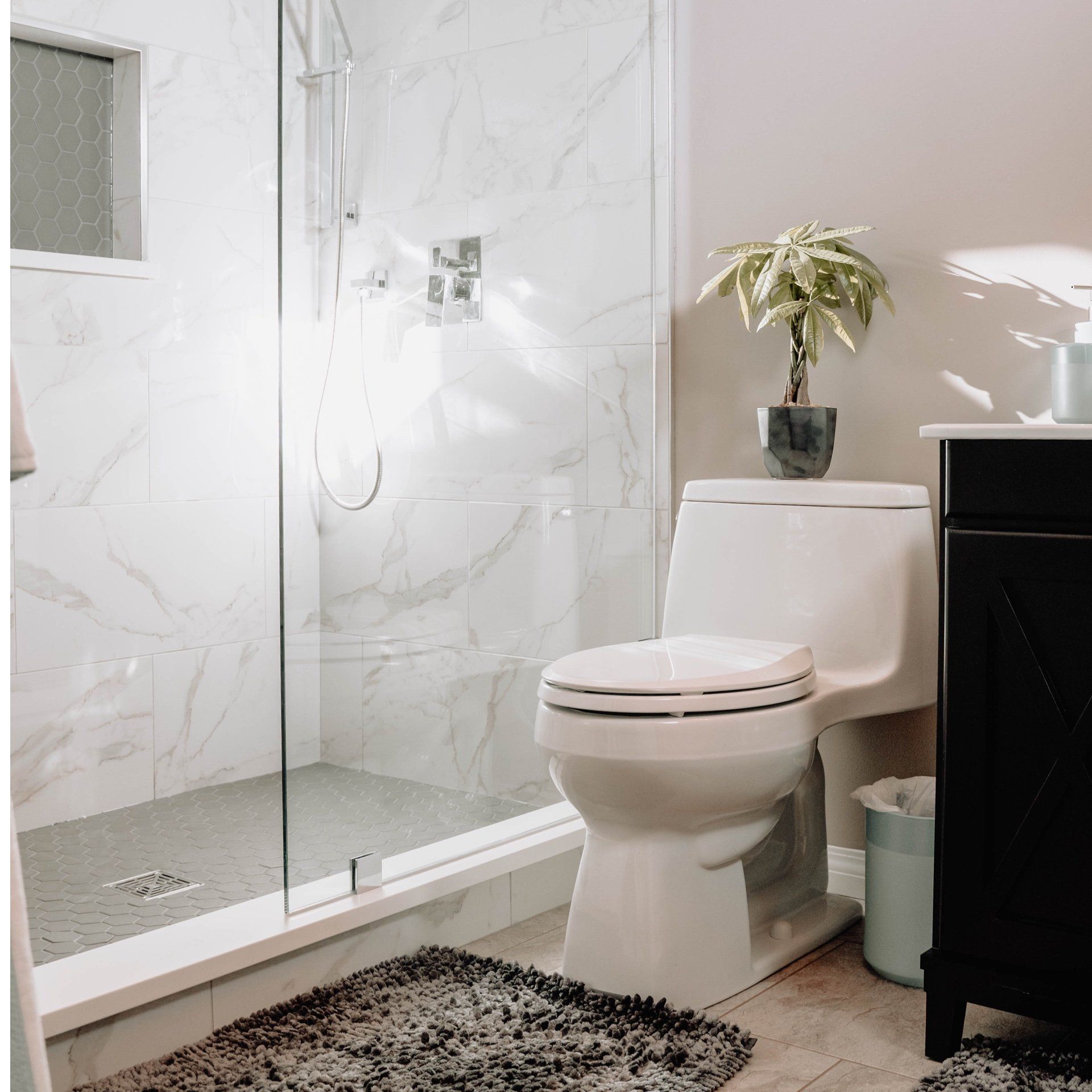A bathroom with a toilet , sink , and shower.