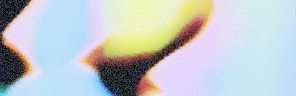 Abstract close-up of a colorful blurred shape with yellow, pink, and blue tones