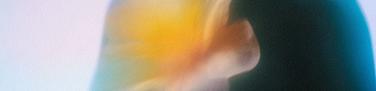 Abstract close-up of a hand with orange and white motion blur against a dark teal background