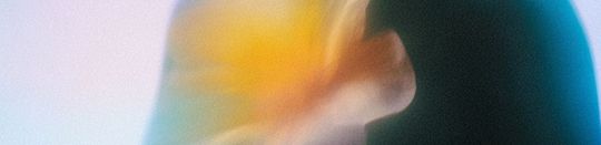 Warm abstract texture representing emotional release and trauma-informed birth support