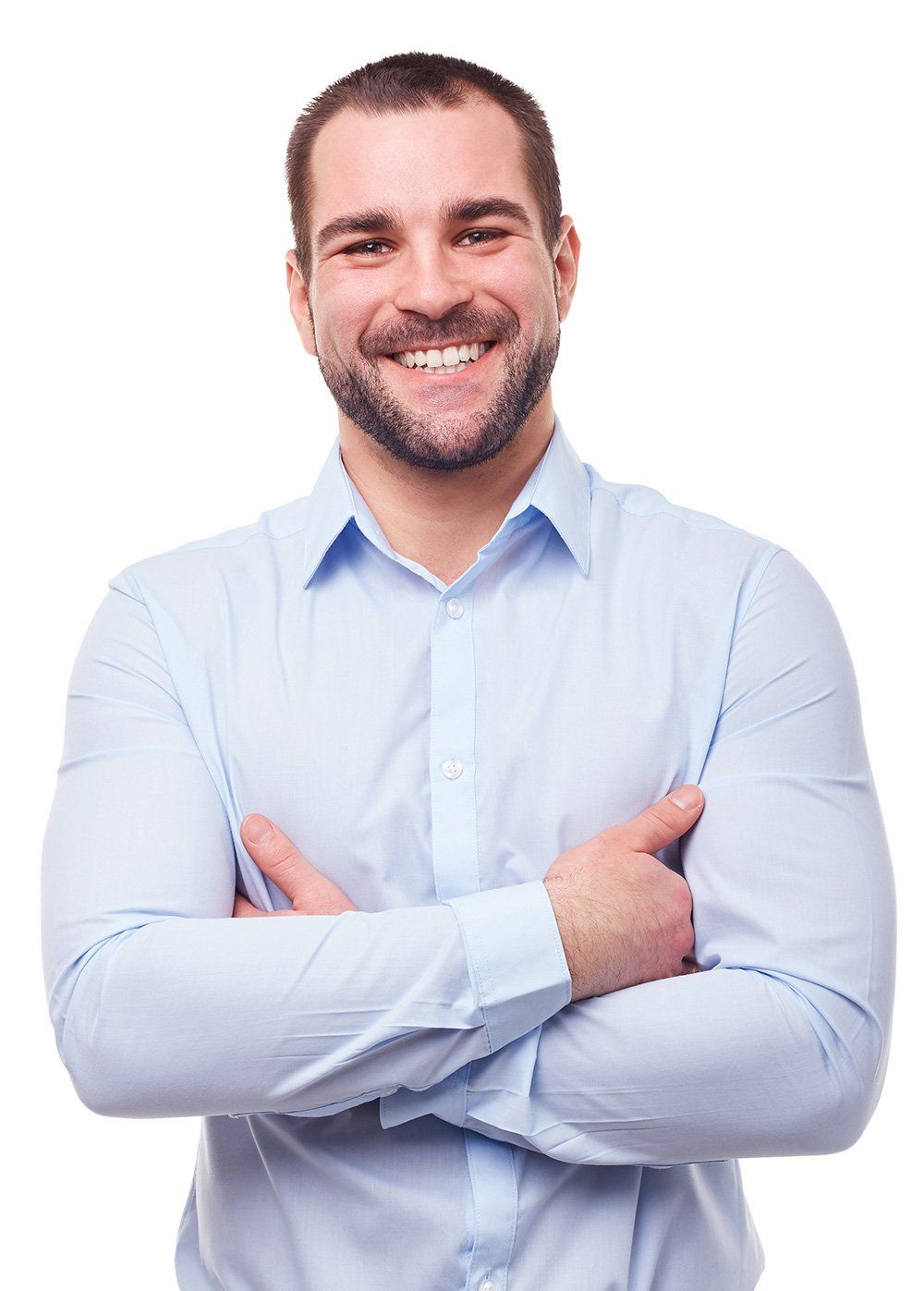 Man with a beard in a blue button-down shirt smiles with arms crossed, against a white background.