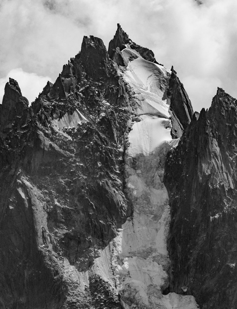 A black and white photo of a mountain covered in snow