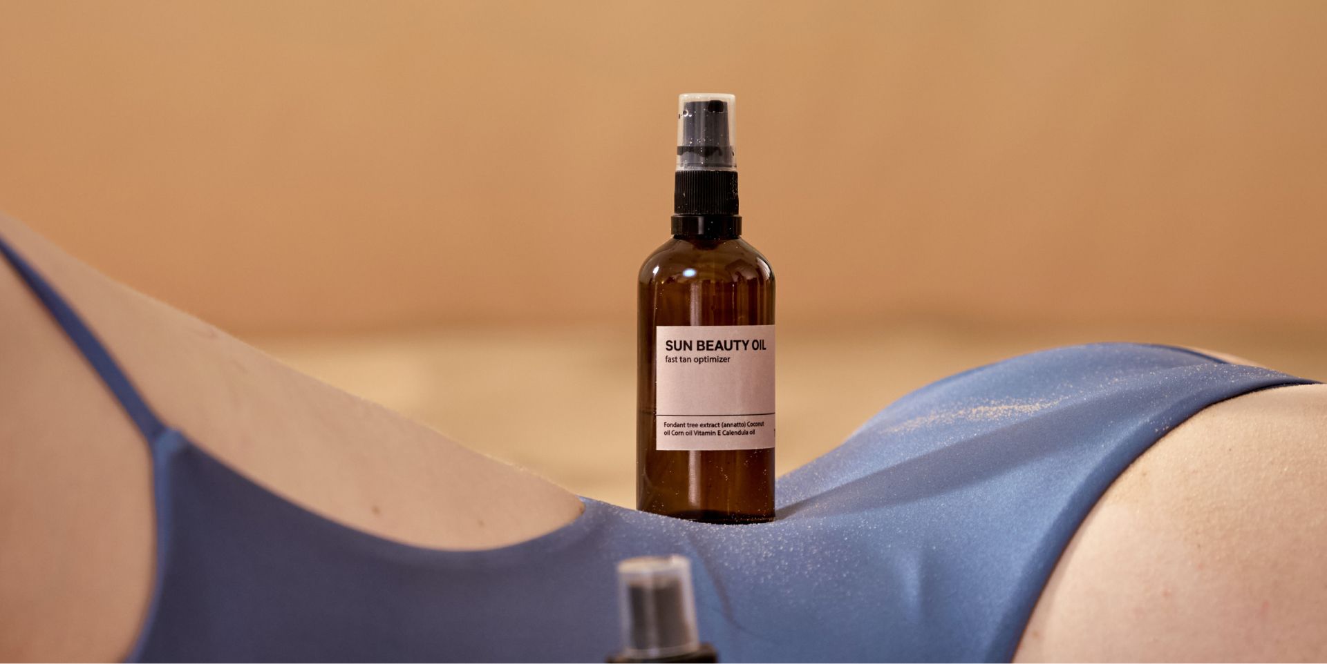 Brown spray bottle on a person's torso covered in a blue garment.