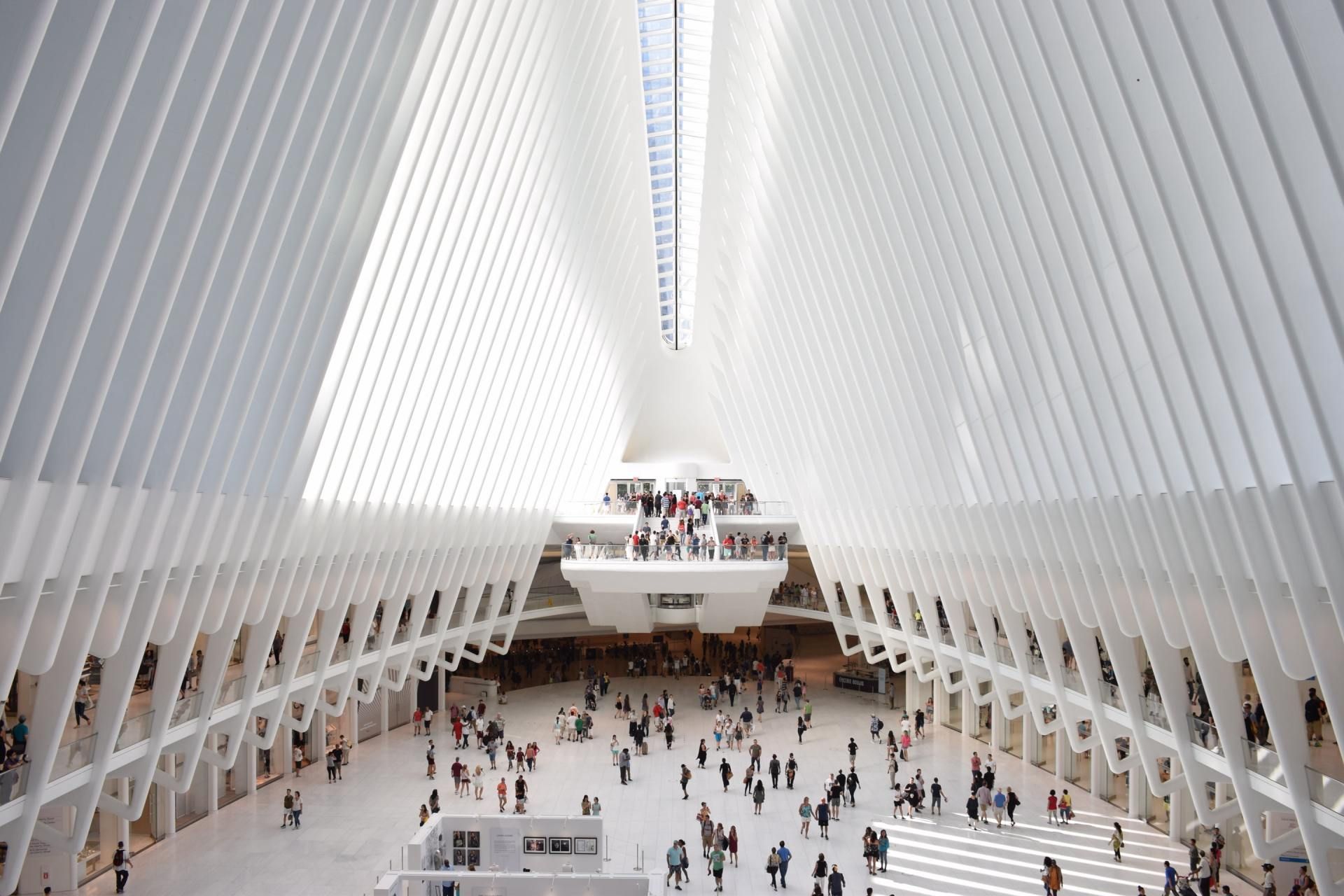 A large white building with a lot of people in it