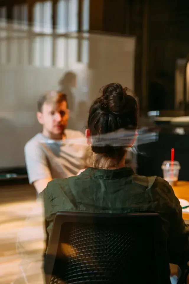 An image of a meeting behind glass doors