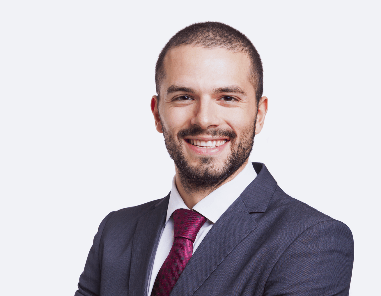 A man in a suit and tie is smiling for the camera.