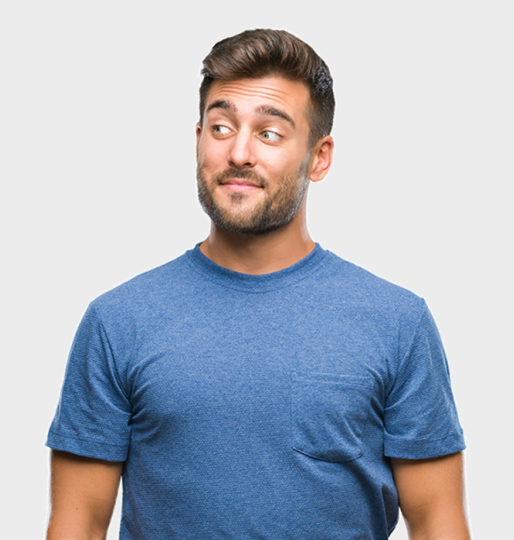 Man in a blue T-shirt looking to the side with a slight smile on a plain light background