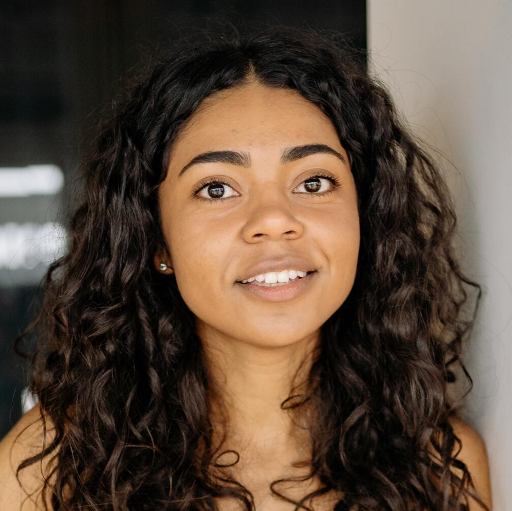Customer with curly hair smiling after using Devil Dog Services dumpster rental
