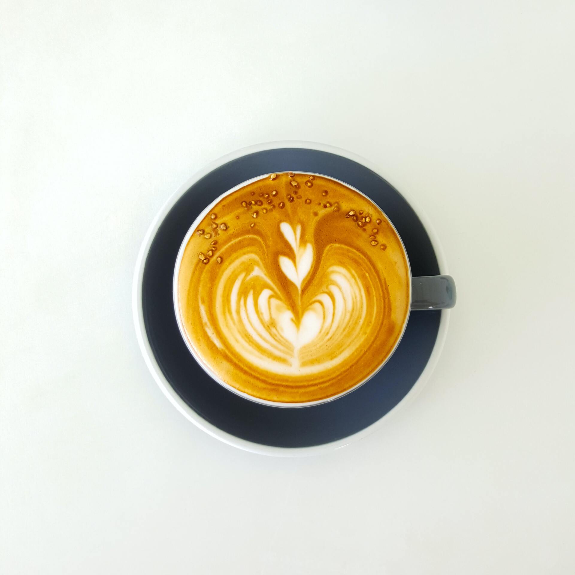 A cup of cappuccino on a saucer on a table
