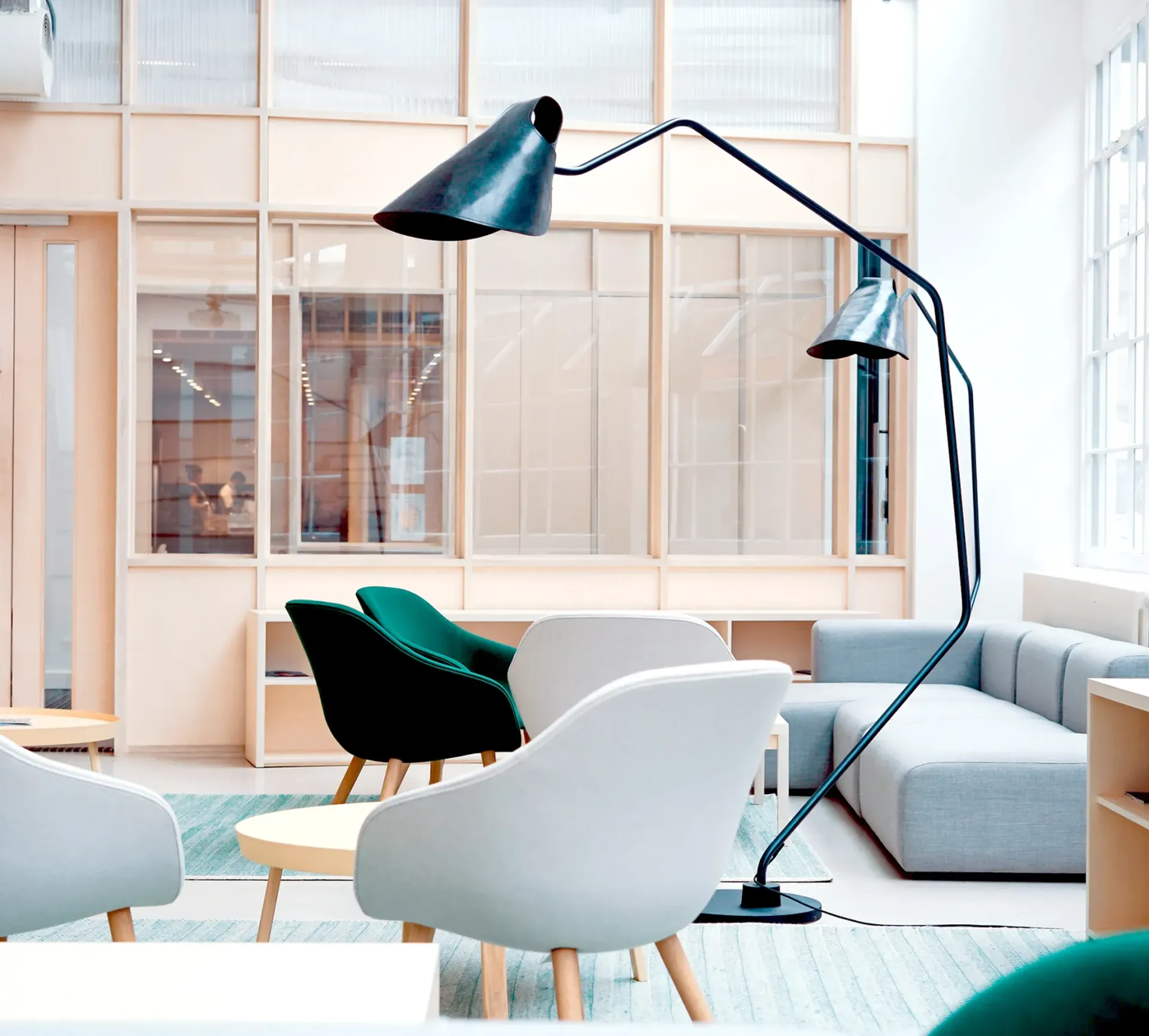 A living room with a couch and chairs and a lamp
