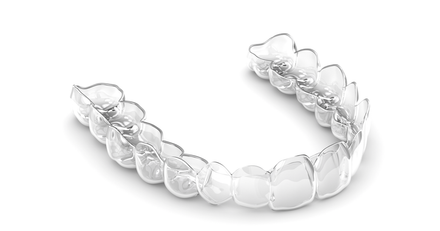 A clear mouth guard is sitting on a white surface.
