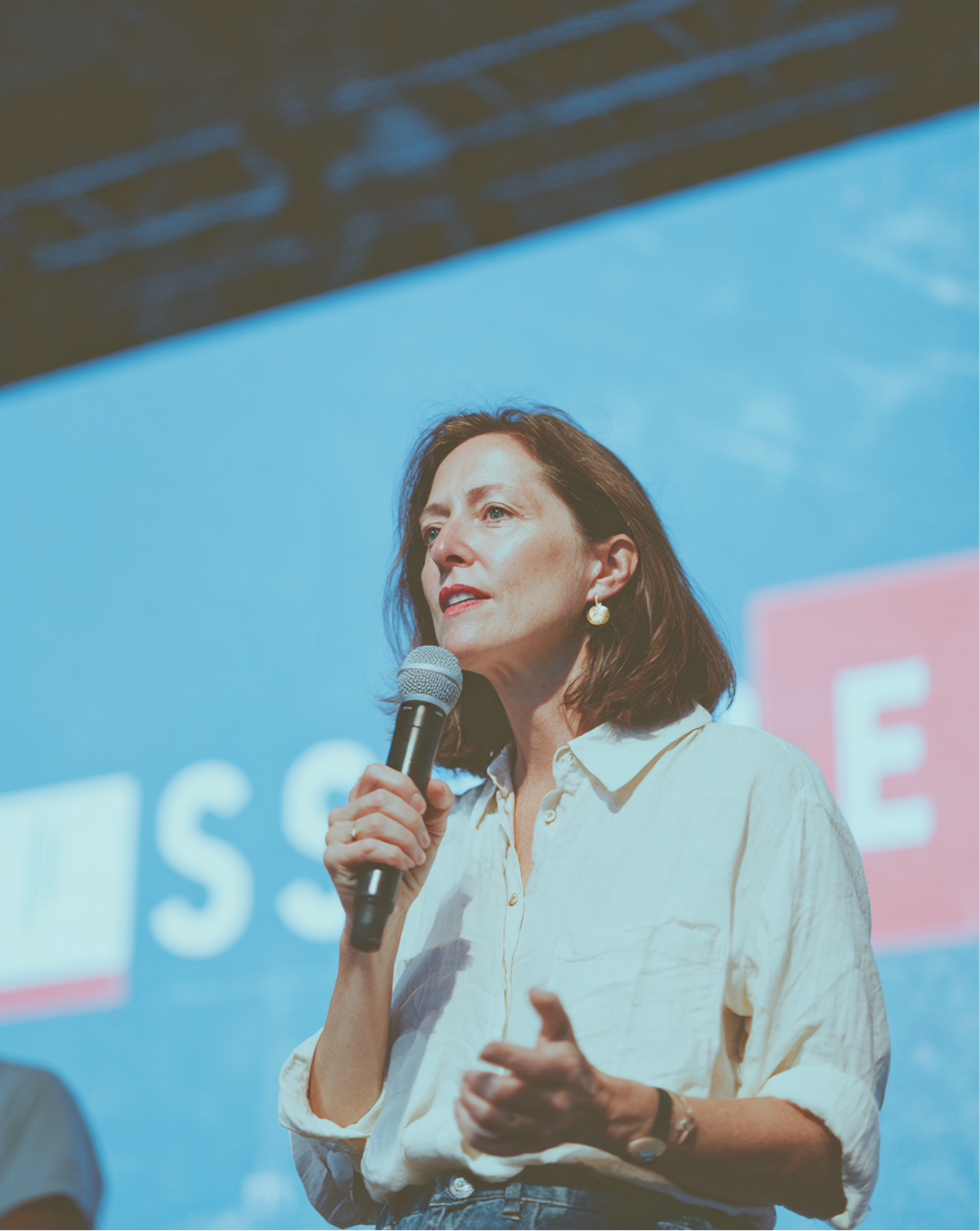 Woman speaking with microphone at conference