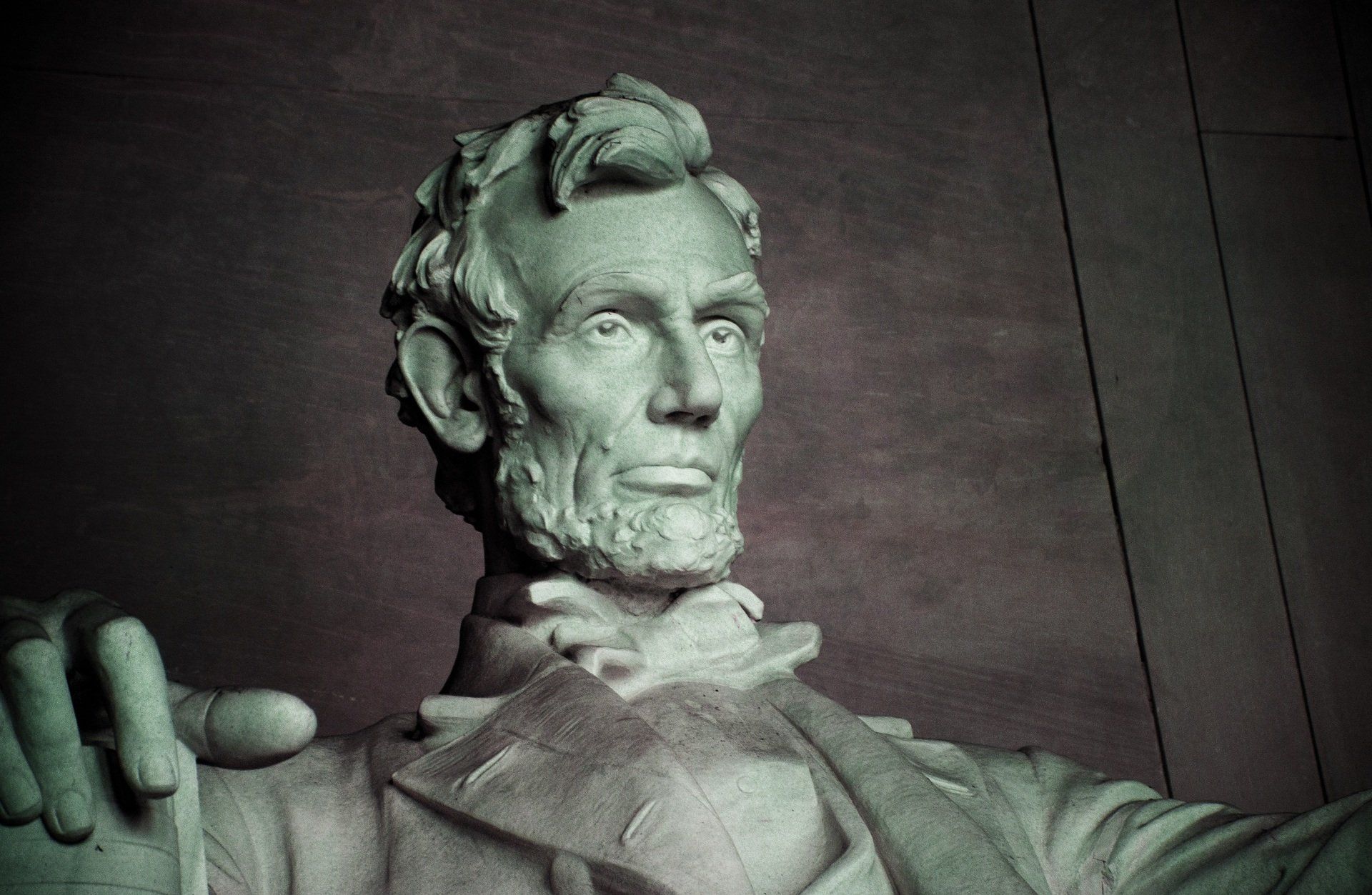 A close up of a statue of abraham lincoln with a beard.