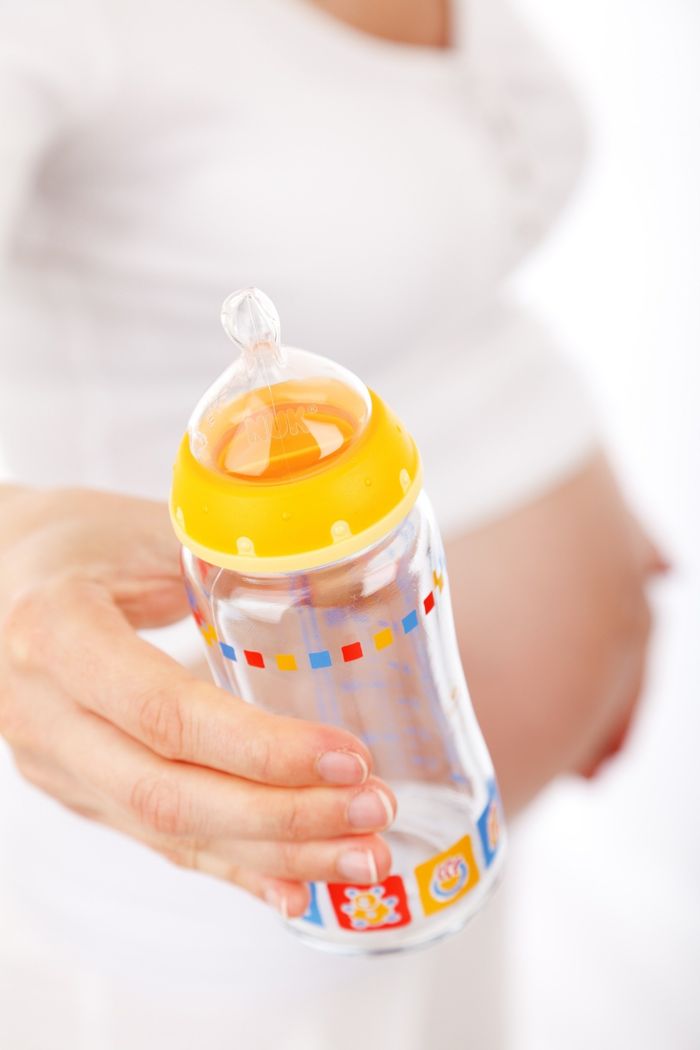 A Hand Holding an Orange Baby Bottle in Boise, ID