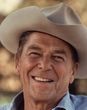 A man wearing a cowboy hat is smiling for the camera