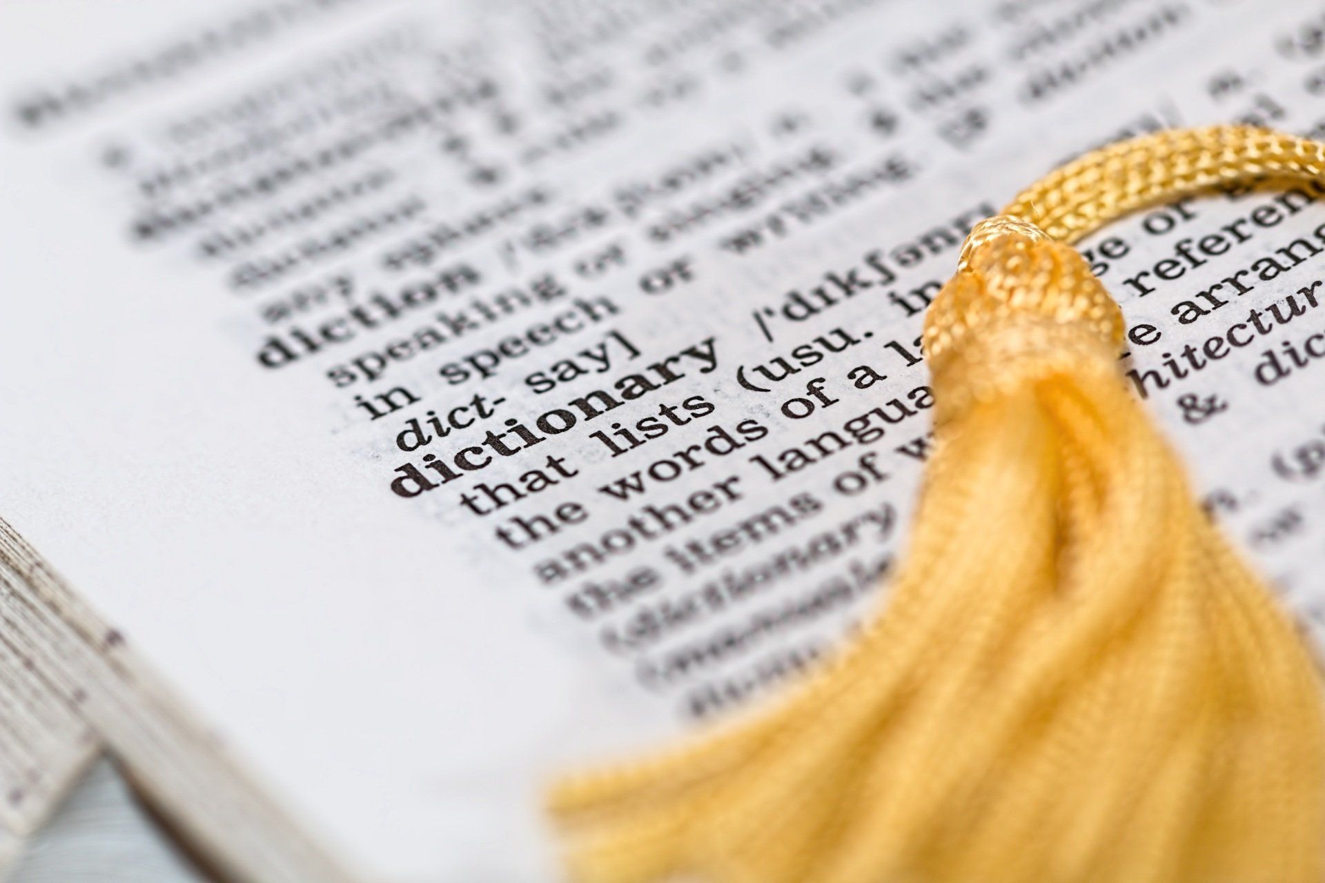 A book is open to a page that says dictionary