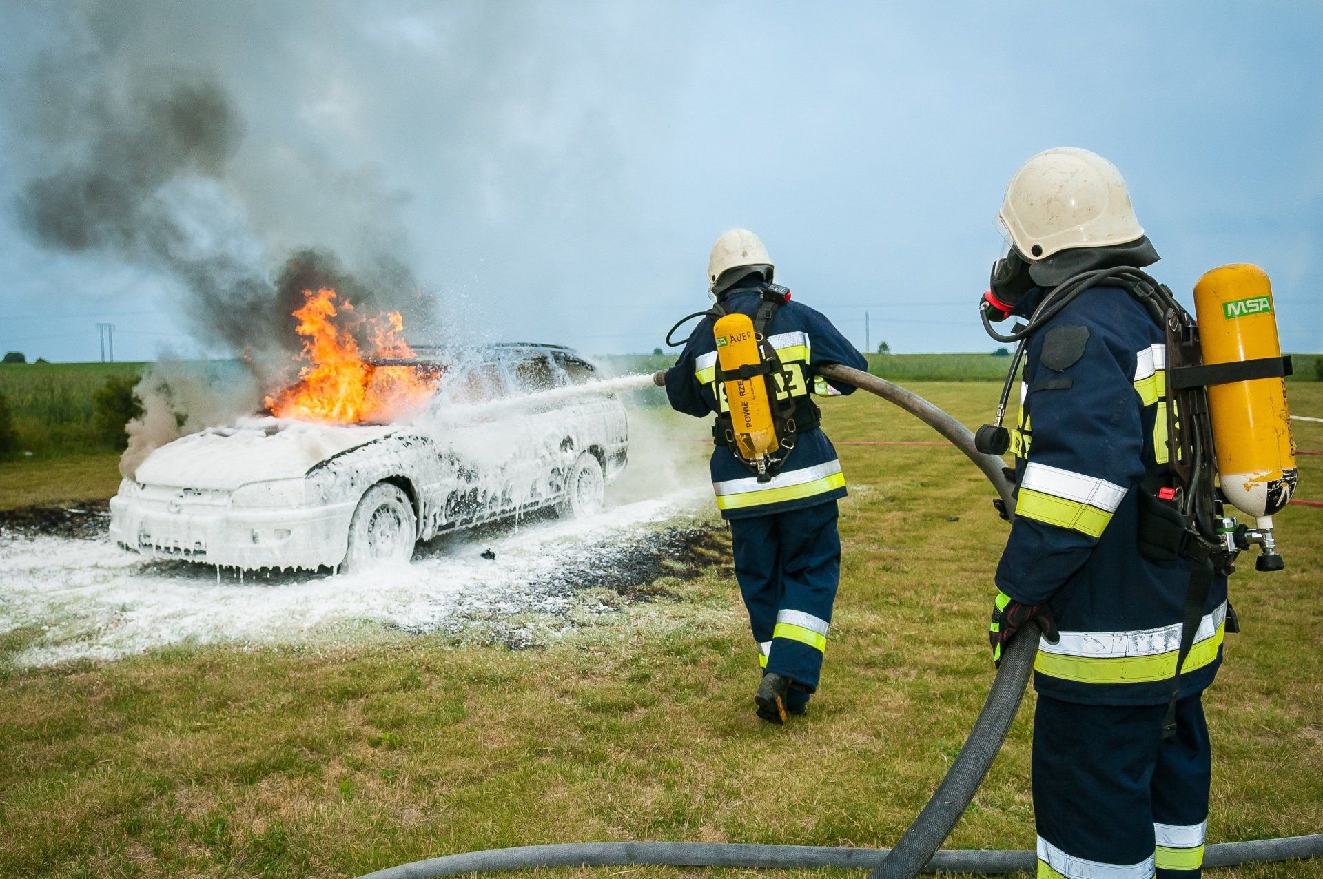 firefighters extinguish a car fire