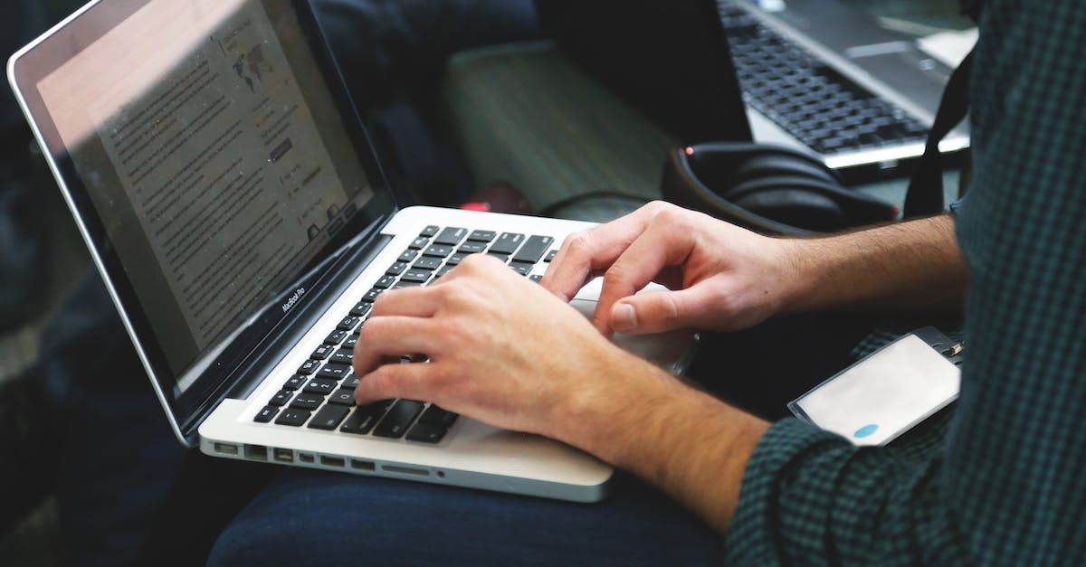 A person is typing on a laptop computer.