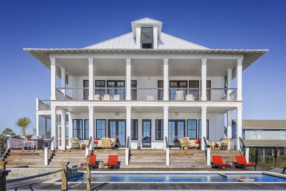 a large white house with a swimming pool in front of it .