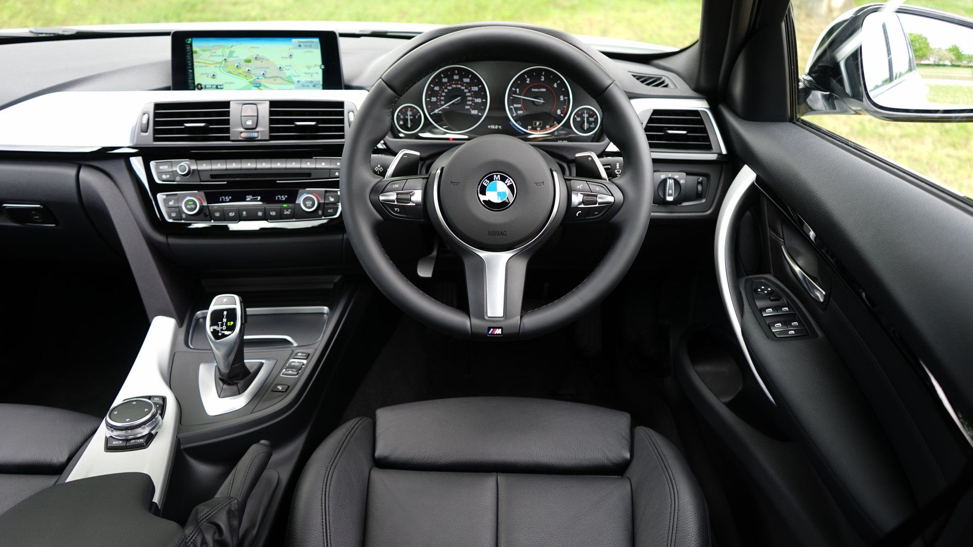 The interior of a bmw car with a steering wheel and dashboard.