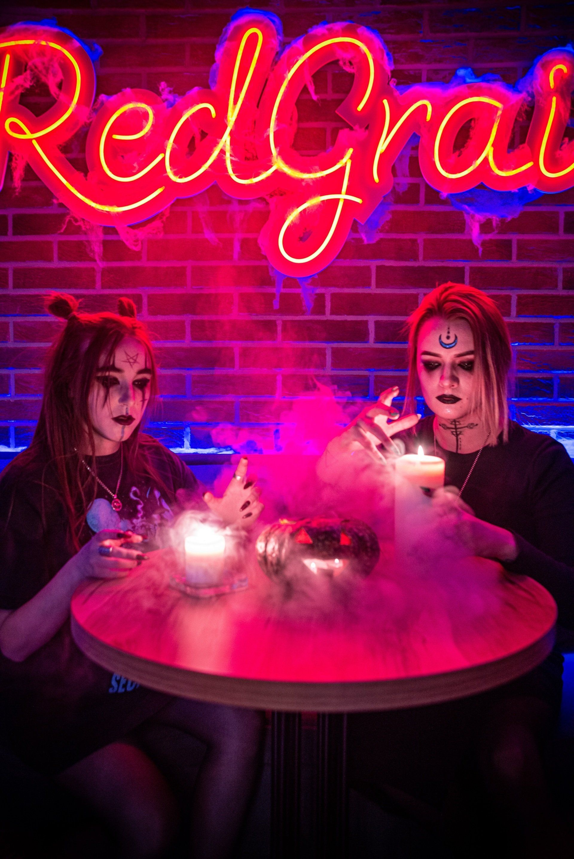 two people with scary face paint making potions