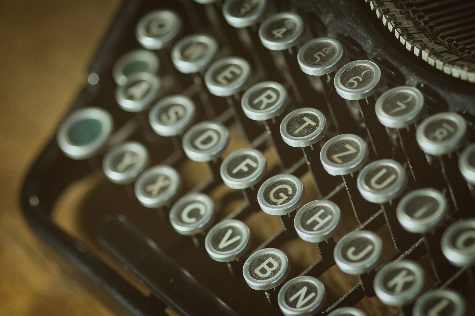 A close up of an old typewriter with the letters a b c d e f g h i j k and l visible