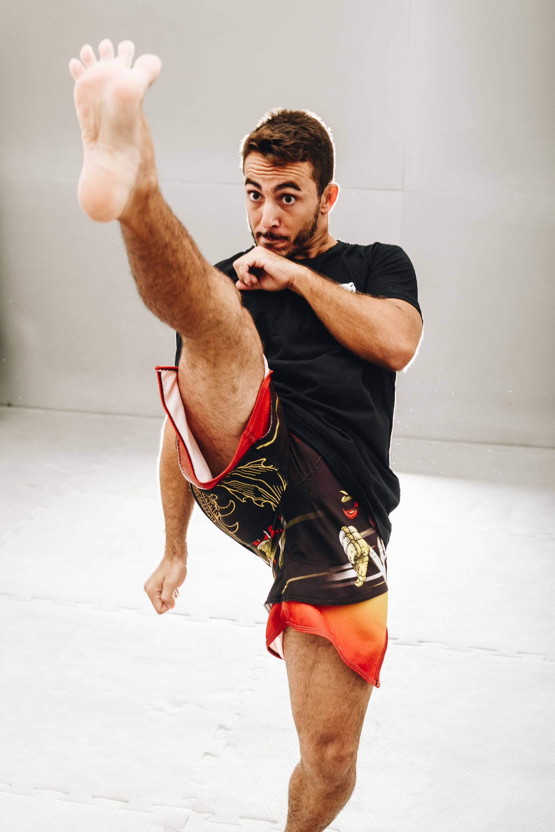 A man is kicking his leg in the air.