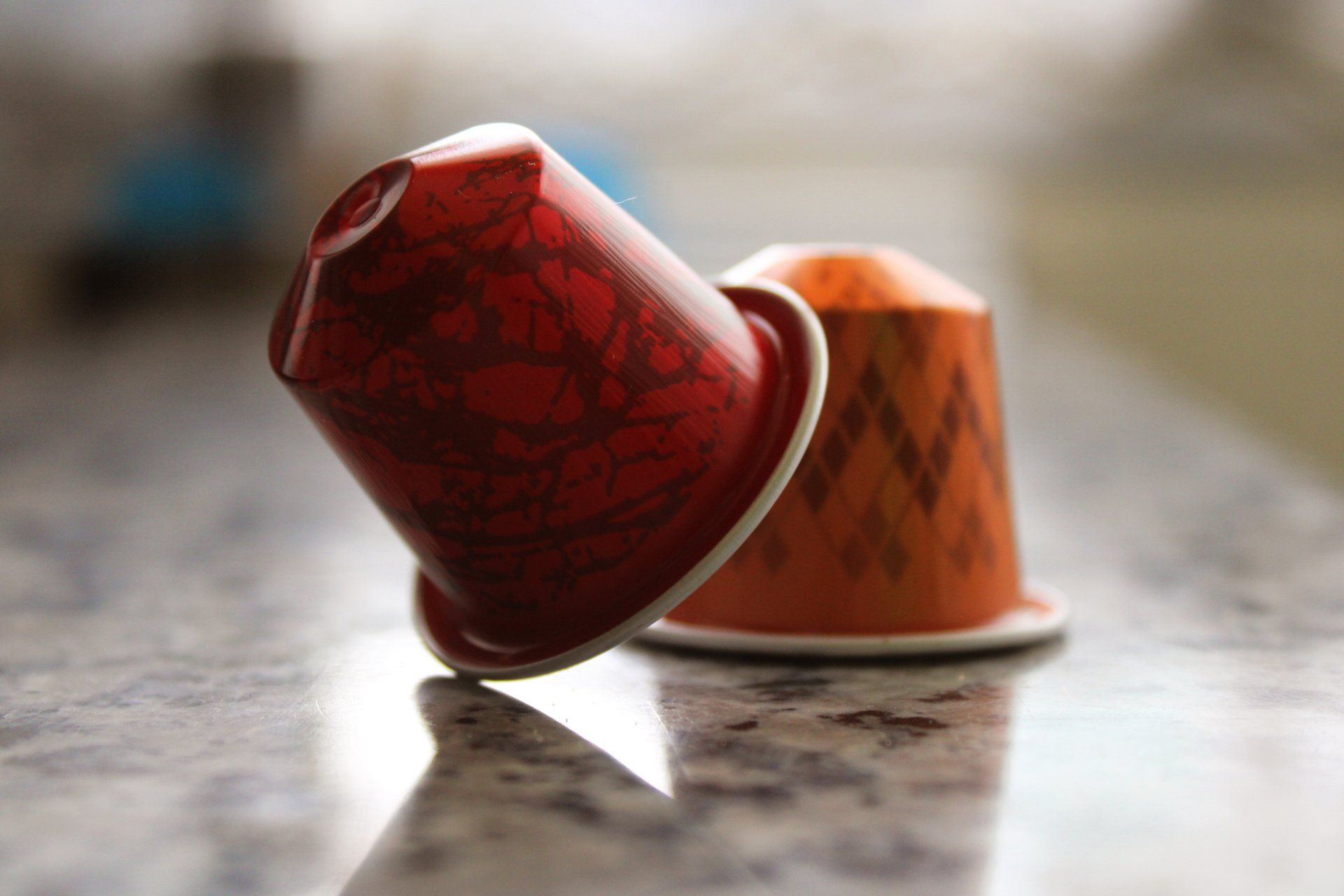 Two nespresso capsules are sitting on a counter top