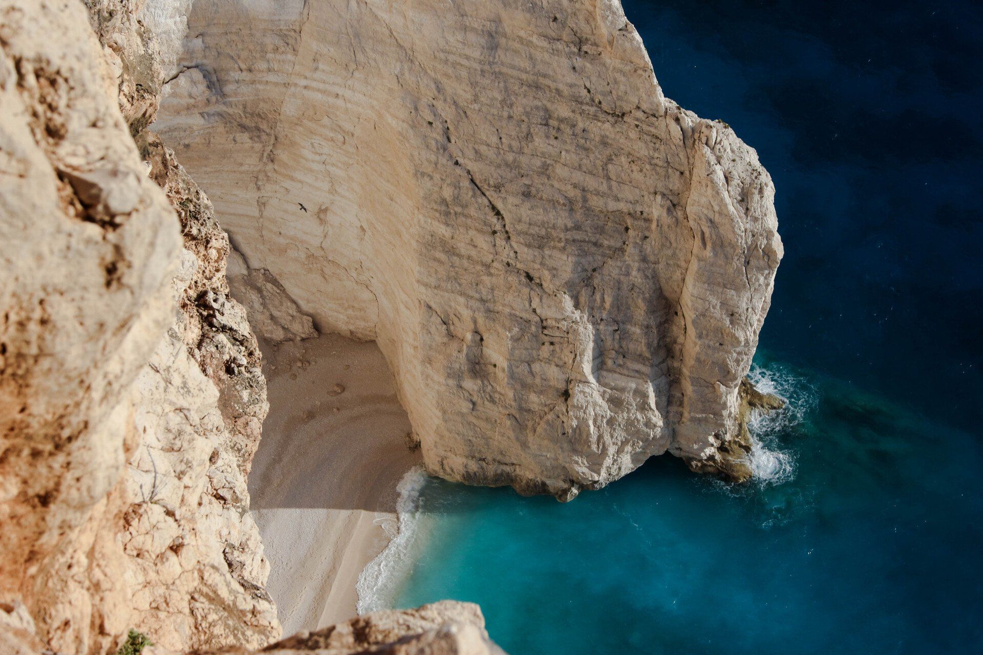 A large rock in the middle of a body of water